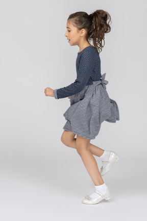 Side view of a girl running in motion